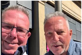 Sir Ian Botham poses for a photo with fishmonger James Mitchell.
