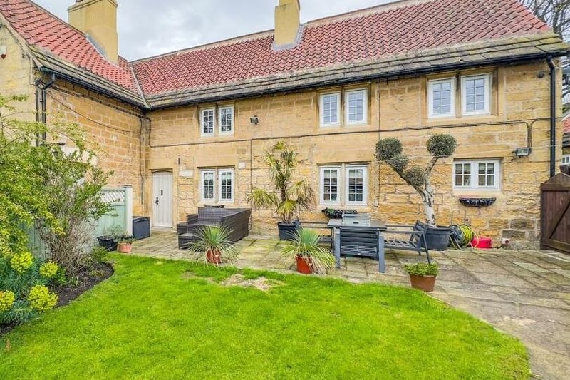 Close-up to the attractive stone period property and patio.