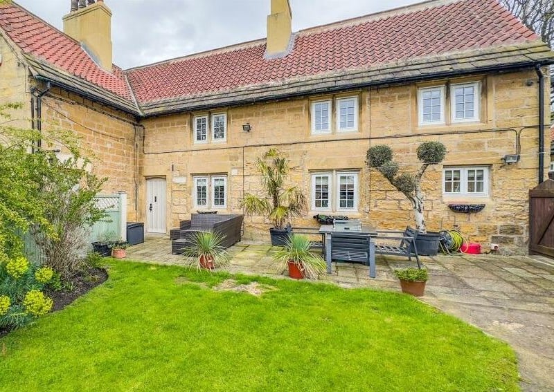 Close-up to the attractive stone period property and patio.
