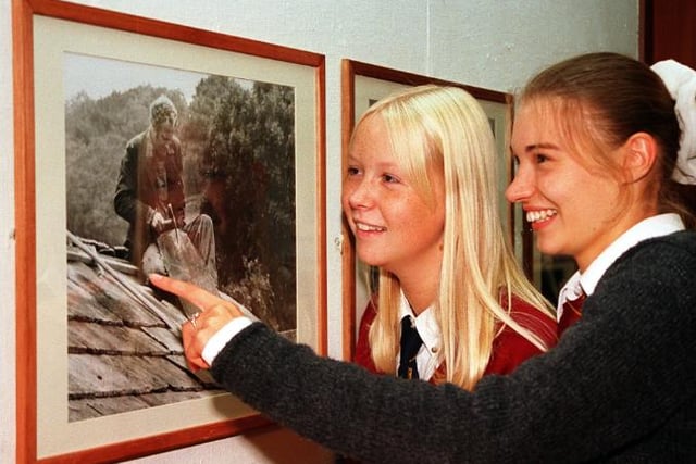 Carlie Betts and Katie Blount from Hallcross Comprehensive are admiring a photograph by David Morgan Rees in 1997.