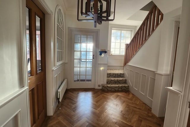 The impressive entrance hall with parquet flooring.