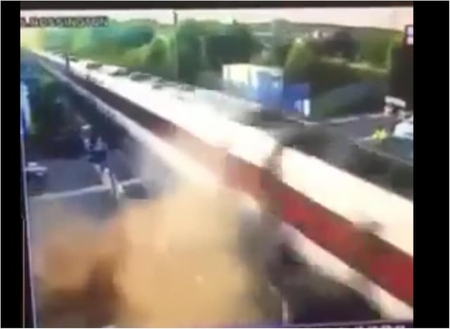 The car is enveloped in a cloud of dust and debris after colliding with a high speed train.