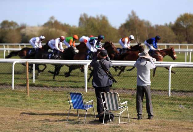 Spectators watch the runners and riders at Doncaster. Photo: Mike Egerton - Pool / Getty Images