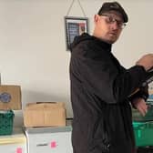 Paul, a volunteer at the Cambeth Community Project stocktaking after a fresh delivery to the Community Fridge in Doncaster.