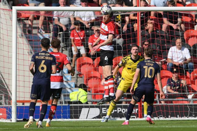 Doncaster Rovers defender Tom Anderson wins a header in the second half against Swindon Town.