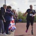 Lisa competing and being cheered on by her supporters