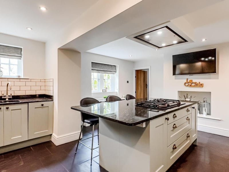 Part of the modern kitchen with central island and breakfast bar.