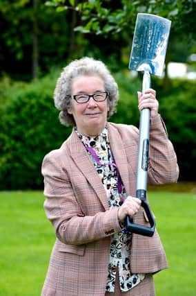 Elizabeth is pictured with the spade used by then Doncaster MP Harold Walker to cut the first sod to mark the start of building work at St John’s on 16 December 1990.