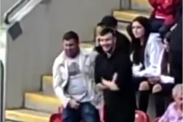 Two men were filmed making offensive gestures and apparently mocking a severely disabled Rotherham United fan.