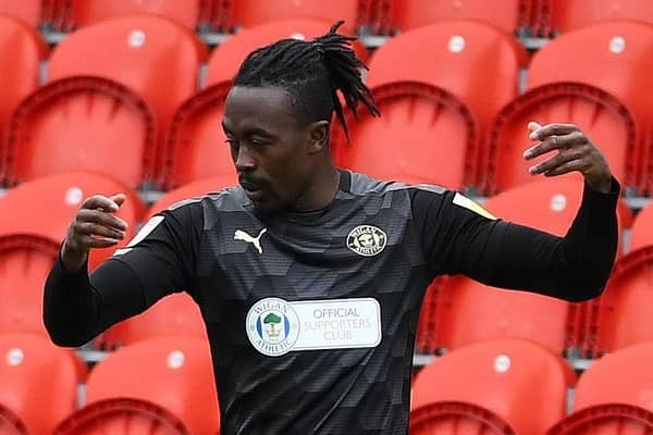 Joe Dodoo celebrates scoring for Wigan at the Keepmoat last season.