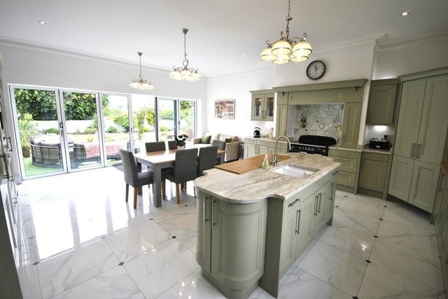 The stunning open plan fitted kitchen has bi-fold doors out to the garden.