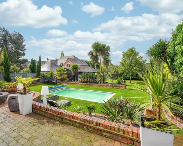 The landscaped garden with a swimming pool as centrepiece also has an outdoor kitchen and bar, a garden room and a covered hot tub area.