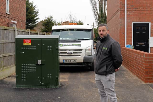Jon-Paul Chambers, Owner at Footprint Builders, pictured by the Fibre Optic Broadband Box, which has been built across the entrance to car parking meant to serve eight properties on West Road, in Moorends. Picture: NDFP-26-01-21-BroadbandBox 2-NMSY