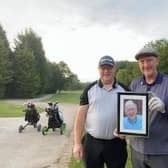 John and his brothers with a photo of their dad