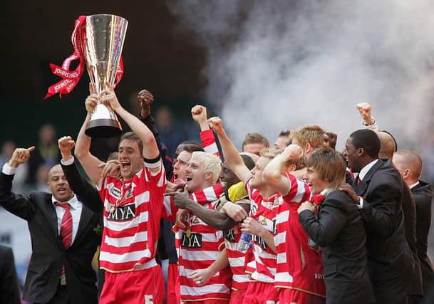 Captain Graeme Lee lifts the Trophy as his Doncaster Rovers team-mates celebrate after the Johnstones Paint Trophy Final win over Bristol Rovers at the Millennium Stadium on April 1, 2007 .