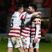 Doncaster's players celebrate Ben Close's goal.