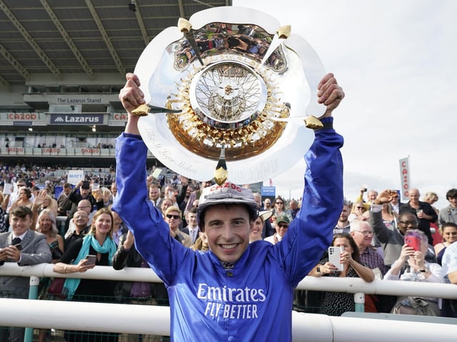 William Buick celebrates with the trophy after riding Hurricane Lane to win in 2021. Photo by Alan Crowhurst/Getty Images.