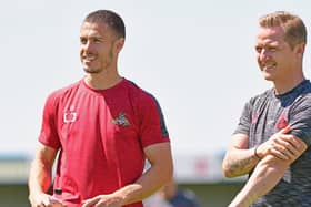 Doncaster Rovers boss Gary McSheffrey with midfielder Tommy Rowe. Photo: Andrew Roe/AHPIX LTD.