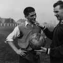 Peter Doherty, right, is pictured in 1959 talking to Johnny Crossan while on managerial duty for Northern Ireland. Picture: Central Press/Getty Images