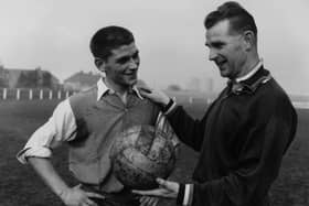 Peter Doherty, right, is pictured in 1959 talking to Johnny Crossan while on managerial duty for Northern Ireland. Picture: Central Press/Getty Images