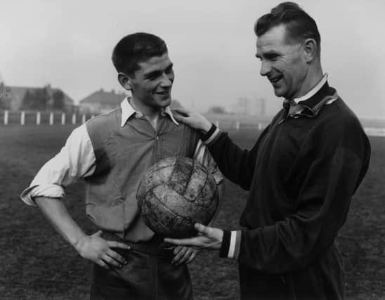 Peter Doherty, right, is pictured in 1959 talking to Johnny Crossan while on managerial duty for Northern Ireland. Picture: Central Press/Getty Images