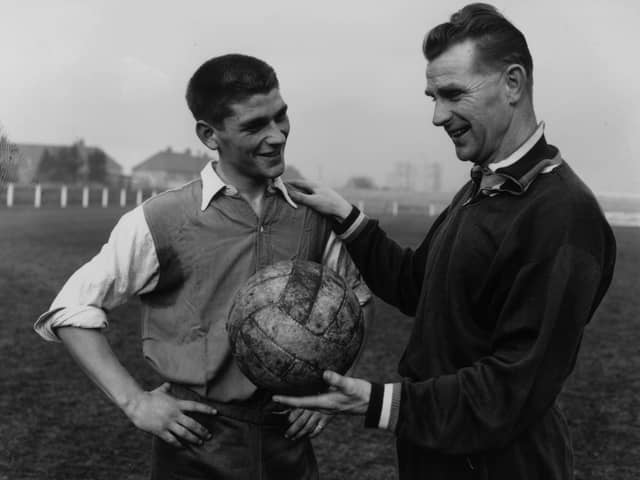 Peter Doherty, right, is pictured in 1959 talking to Johnny Crossan while on managerial duty for Northern Ireland. Picture: Central Press/Getty Images