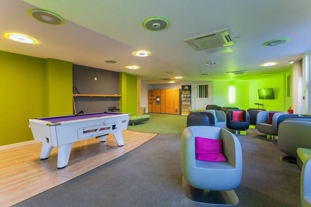 Games room with pool table, seating and television areas that is available to all residents.