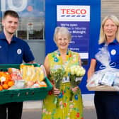 Maureen collecting the first donation of flowers and fruit from store colleagues Micky and Nicola