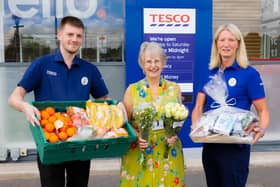 Maureen collecting the first donation of flowers and fruit from store colleagues Micky and Nicola
