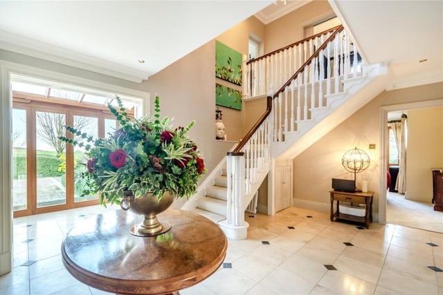 The impressive light-filled hallway has an open turned staircase leading up to the first floor.