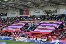 The huge surfer flag, on display against Wimbledon last season, that was crowdfunded by the Black Bank group.