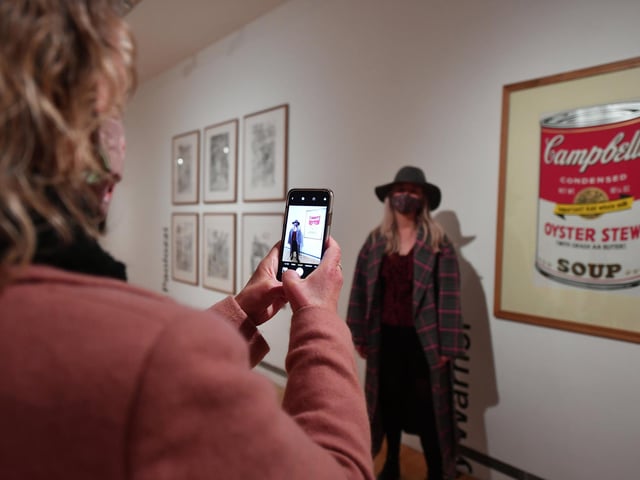 Visitors in front of an Andy Warhol print.