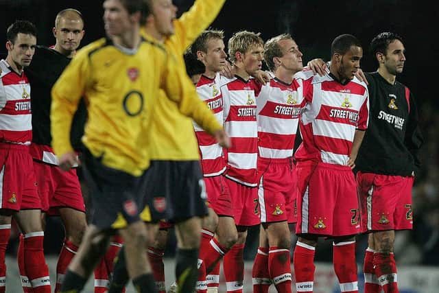 Arsenal celebrate their shoot-out win as the Doncaster team look on. Photo: Ross Kinnaird/Getty Images