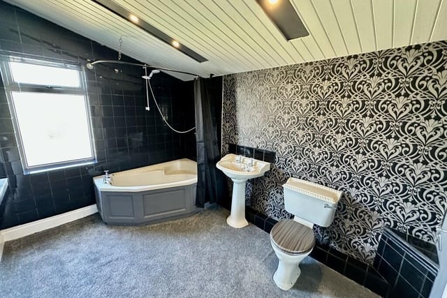 A stylish bathroom with corner bath.