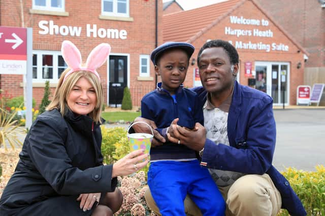 Linden Homes sales executive Kathy with Harper’s Heath residents Joel Memukula and his five-year-old Benjamin