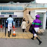 Jockeys return to their makeshift weighing room in the exhibition hall at Doncaster Racecourse. Photo by Alan Crowhurst/Getty Images
