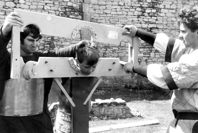 Not many people can say that they have been placed in the stocks at Conisbrough Castle but back in 1992 nine year old William Hyland from Conisbrough had the honour. He is assisted by Nigel Pettitt and Jonathon Martin.