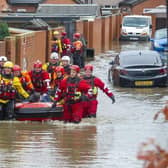 8 November 2019...... The RLNI and fire rescue officers evacuate a man from a property on Yarborough Terrace on a flooded estate in Bentley, Doncaster after the River Don Burst its banks. Picture Tony Johnson