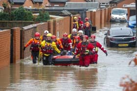 8 November 2019...... The RLNI and fire rescue officers evacuate a man from a property on Yarborough Terrace on a flooded estate in Bentley, Doncaster after the River Don Burst its banks. Picture Tony Johnson