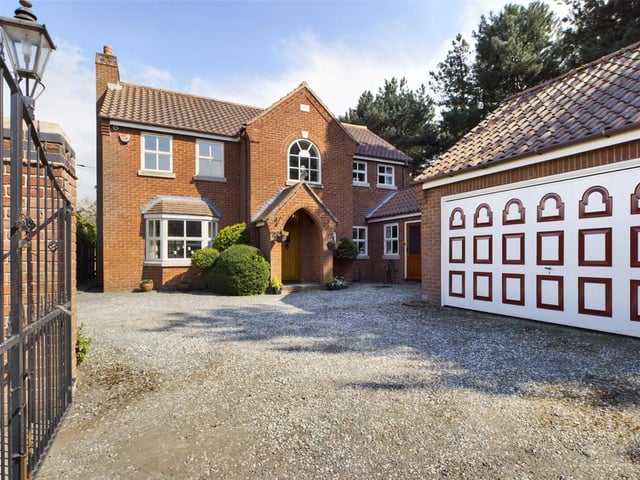 Front view of The Pines, a driveway providing plenty off road parking and access to the double garage.