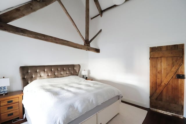 A double bedroom with vaulted ceiling within the cottage.