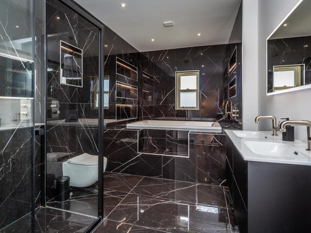 A super stylish bathroom is one of four within the house.