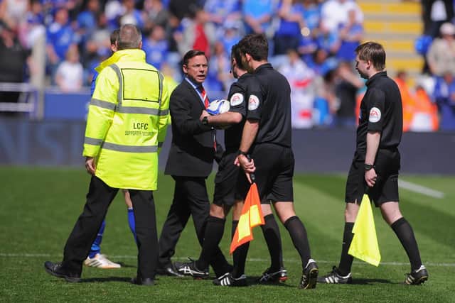 Paul Dickov remonstrates with referee Paul Tierney after the game