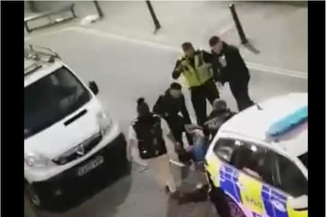 Police were filmed restraining a couple in Scot Lane last night. (Photo/Video: Joel Scholey).