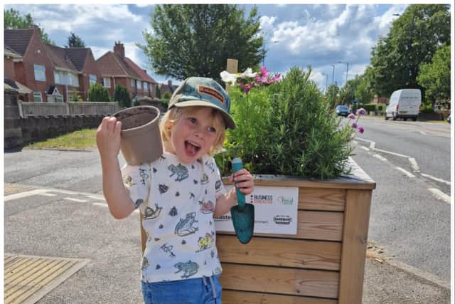 Logan is all smiles again after vandals stole a bug hotel from a community planter in Armthorpe.