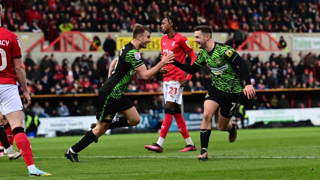 Luke Molyneux celebrates his second goal with George Miller.