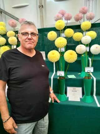 Paul pictured with some of his prize winning dahlias at The National Dahlia Society Northern National Show, formerly known as Harrogate Show.