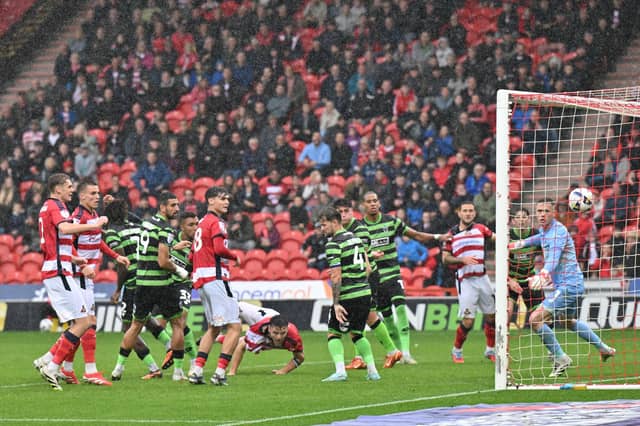 Doncasters' Owen Bailey heads in Rover's first goal.
Picture Bruce Rollinson/AHPIX LTD; Football,
SkyBet League 1; Season 25/26
Doncaster Rovers v AFC Wimbledon.
20/09/2025; 15.00; Eco-Power Stadium.