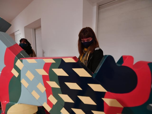 Visitors study as scuplture by Eduardo Paolozzi, Hamlet in a Japanese Manner..