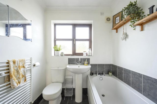 Family baathroom - Fitted with a WC, a wash hand basin and panel bath. There is an obscure double glazed window, splash back tiling, a heated towel rail, an extractor fan and tiling to the floor.
